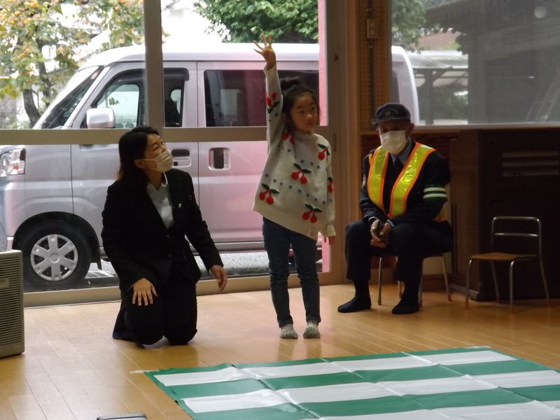 手を挙げて横断歩道を渡る練習をする子供2