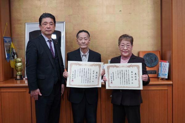 表彰状とともに左から守田市長、萩原さん、西山さんの写真