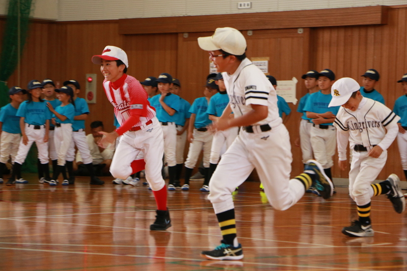 盗塁の指導を受け、走る子どもたちの写真