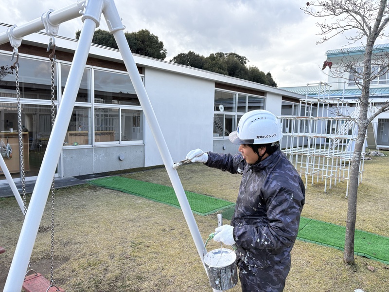 技術員がブランコに塗装する写真.JPEG